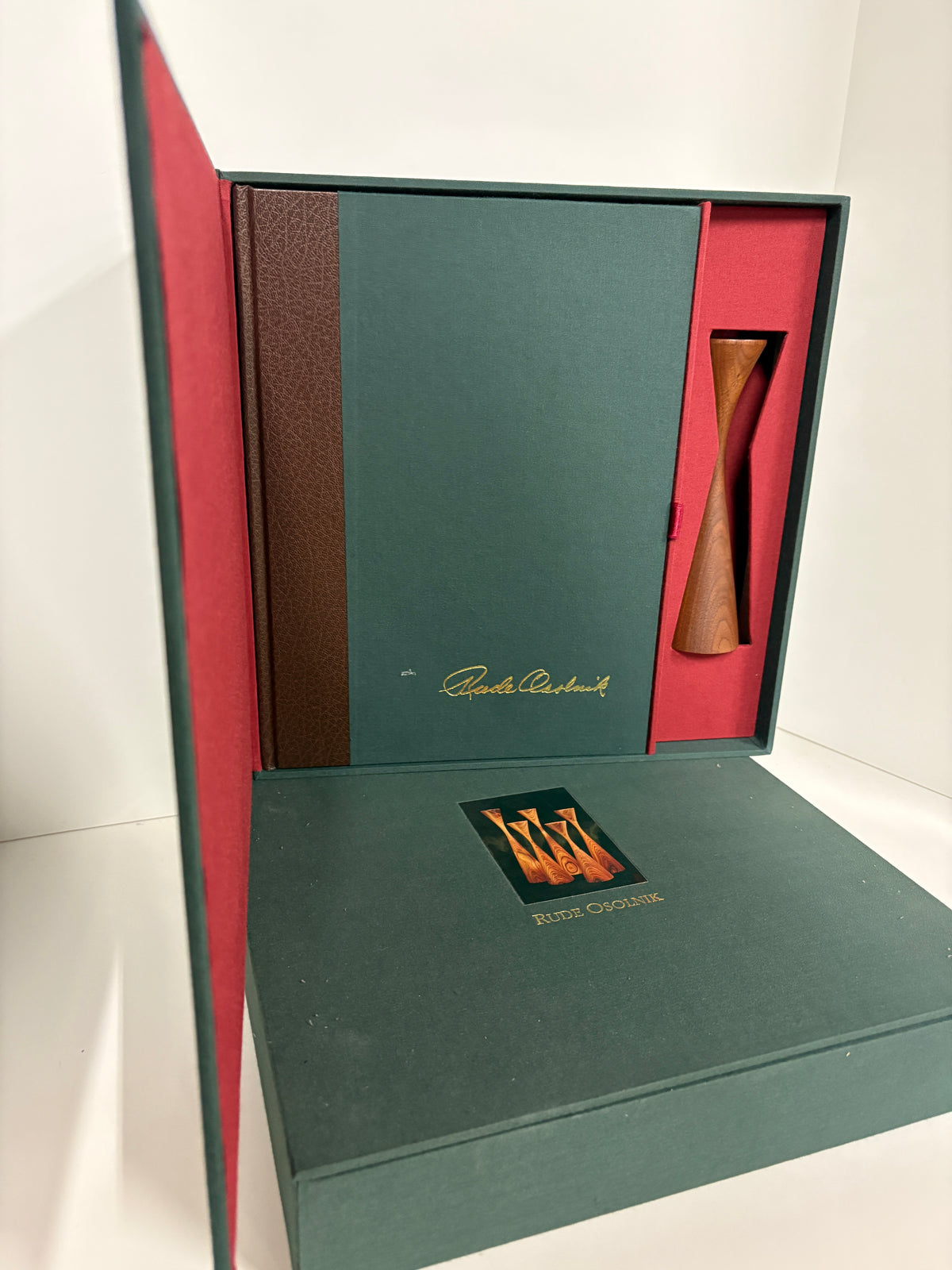 Rude Osolnik special edition presentation set open, showing signed book with gold signature, turned walnut candleholder in red velvet compartment"
