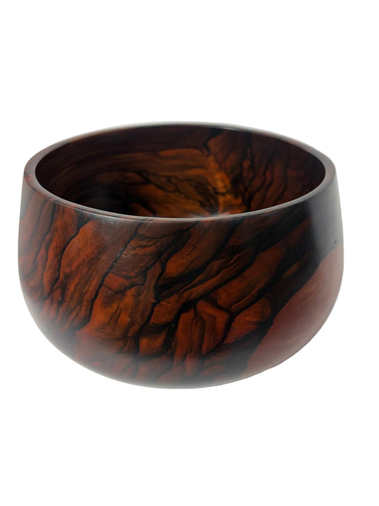 A round wooden bowl with a rich, swirling dark brown and reddish-brown wood grain pattern