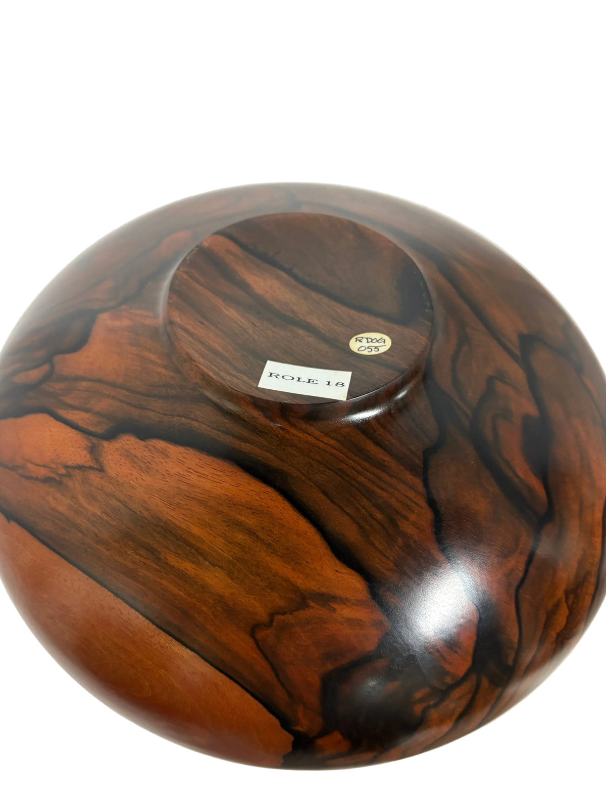 Wooden bowl with a visible brand label